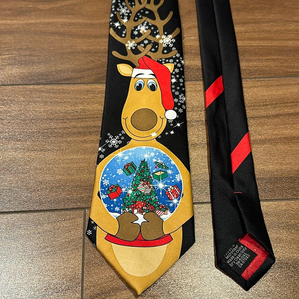 Christmas reindeer holding a snow globe tie